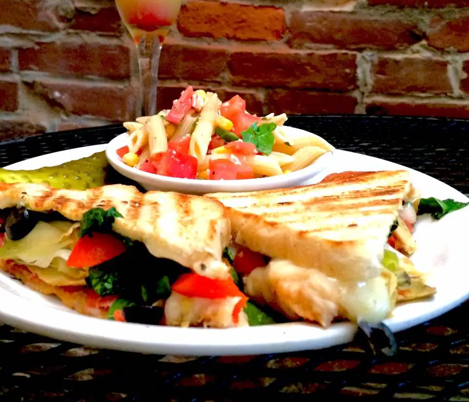 Pepperoni roasted red peppers, provolone cheese, spinach, black olives, marinated artichoke hearts and mozzarella grilled on sourdough bread make this antipasto sandwich at Toast on Market in Louisville